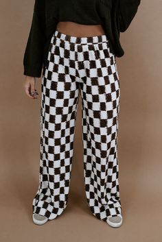 When comfort meets style. The All Things Checkered Velvet Pants will be turning heads. This checkered pant is featured in a, relaxed high stretch fit with a brown/white checkered pattern and high rise waistband for a true cool girl energy look. Waistband: Elastic Fabric: 100% Polyester Elastic waistband High stretch fabrication Wide leg bottom Imported Fit: True to size!- Waistband: Elastic- Leg: Wide leg- Generous stretchModel Specs: Emily + Karli are wearing a size small in the photo.How will this item fit you? Check out our MODEL SPECS (Typical Sizing - Karli: S-Size 5/26 - 5ft 2in, Emily: S-Size 3/25 - 5ft 5in, Syd: L/XL- Size 15/ - 5ft 8in)﻿Need help with sizing? No problem! Join our VIP group on Facebook, Everyday Chic Boutique VIP Insiders to chat directly with our team and other cu Checkered Clothes, Velvet Pant, Girl Energy, Checkered Pants, Everyday Chic, Velvet Pants, Elastic Fabric, Pencil Skirts, Edgy Outfits