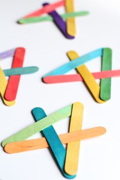 four pops sticks are arranged in the shape of an x on a white table top