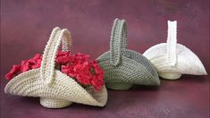 three crocheted baskets with flowers in them