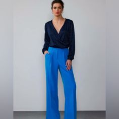 Wear These Beautiful Wide Leg Trousers Alone Or Bundle With The Coordinating Vest Which Is Also Being Sold Separately To Create The Perfect Power Suit. The Deep Azure Blue Color Is A Gorgeous Alternative To The Standard Neutral. Us Size: 14 Length Waist To Hemline: 43” Waist: 32-33” Fabrics: 80% Polyester, 11% Spandex Blue Trousers Outfit Casual, Chic Blue V-neck Pantsuit, Chic Blue Bottoms For Date Night, Tailored Blue Bottoms For Party, Elegant Blue Bottoms For Formal Occasions, Blue Summer Pantsuit For Party, Elegant Blue Bottoms For Workwear, Blue Pantsuit For Summer Party, Elegant Blue Wide Leg Pantsuit