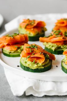 cucumbers with smoked salmon and avocado on a white plate, ready to be eaten