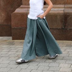 "Introducing our Linen Wrap Maxi Skirt - a versatile and elegant piece with convenient pockets for added functionality. Crafted from high-quality linen, it offers comfort and breathability for any occasion. The wrap design ensures easy wearability, and the adjustable tie allows for a customizable fit.  DETAILS ⚬ Wrap design. ⚬ Ties at side. ⚬ Side pockets. ⚬ Made of Oeko-Tex-certified linen. ⚬ The linen is NOT see-through. ⚬ Shown here in Teal green.  FIT / SIZE ⚬ Wraparound design, ties at the waist for an adjustable fit. ⚬ Maxi length skirt at 38.9\" long (99cm).  If you would like to add or subtract 10cm from the length, let us know. ⚬ Handmade to order (can be made-to-measure, please write down your measurements in the personalization box) ⚬ Sizes XXS to 4XL (please see detailed size c Full Length Cotton Skirt With Side Pockets, Solid Full Skirt Bottoms With Pockets, Solid Color Full Skirt Bottoms With Pockets, Relaxed Maxi Skirt With Pockets, Relaxed Fit Skirted Bottoms With Pockets, Full Length Flowy Skirt With Pockets, Casual Pleated Full Skirt Bottoms, Full Length Cotton Lined Skirt, Casual Full Pleated Skirt