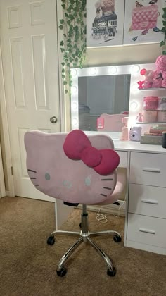 a pink hello kitty desk chair in front of a vanity with a mirror and drawers