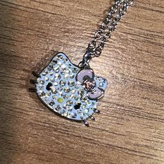 a hello kitty necklace on a wooden table