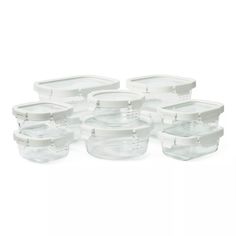 six clear storage containers with lids on each side and one empty container in the middle