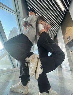 two people are posing for a photo in an airport