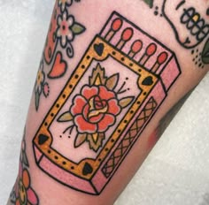 a close up of a person's leg with tattoos on it and a flower in the center