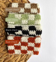 four crocheted dishcloths sitting on top of a woven wicker basket