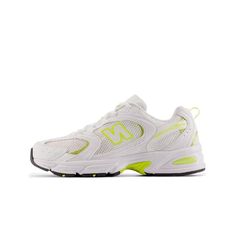 the new balance 997 running shoe in white and neon yellow