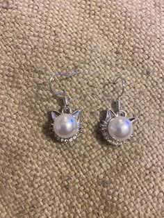 These pretty, pearl simulant and cubic zirconia cat earrings are perfect for that cat lover in your life! These are small/medium  sized earrings and are finished with ear wire to fit perfectly into your earlobes! Show your love for your pets with these earrings!  Like what you see? View more at: https://www.etsy.com/shop/StephsCraftingBits Drop Earrings With Cat Design For Gifts, Dangle Earrings With Cat Design For Gifts, Cheap Cat Design Dangle Jewelry, Cute Silver Cat Design Earrings, Silver Cat Design Dangle Earrings, Cat Earrings, Kitty Cats, Cat Mom, Ear Wire