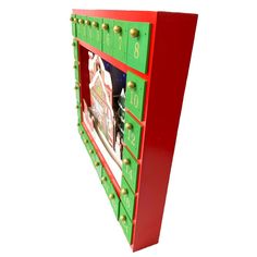 a red and green cabinet with gold studded handles