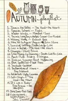 an autumn leaf with the words autumn playlist written on it in front of a lined notebook