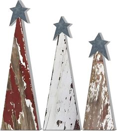 three wooden christmas trees painted red, white and blue with stars on each one side