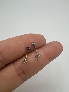 a person's hand holding two tiny keys