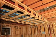 the inside of a house being built with wood framing and insulation tape on the ceiling