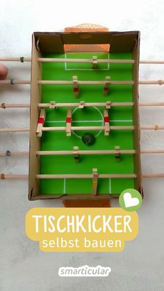 a box that has some kind of foosball game in it with the words tischkicker selbst bauen