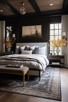 a bedroom with black walls and wood flooring has a large bed in the middle