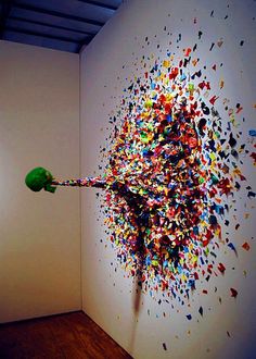 an art work is displayed on the wall with sprinkles all over it