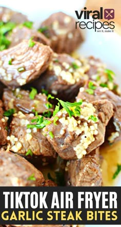 a close up of food on a plate with the words tiktok air fryer garlic steak bites