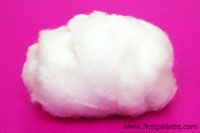 a cotton ball on a pink background