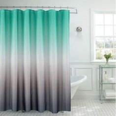 a bathroom with a shower curtain and tub