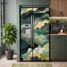 a kitchen with green walls and an artistic design on the side of the refrigerator door