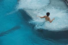 a woman is in the water on a wave machine