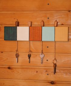 there are many keys hanging on the wall with different colors and shapes to choose from