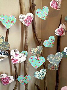 an instagram page with paper hearts hanging from tree branches in the shape of flowers