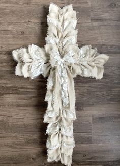 a cross made out of fabric on top of a wooden floor