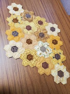 a wooden table topped with lots of different types of hexagons