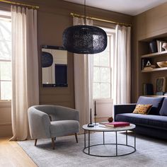 a living room filled with furniture and windows