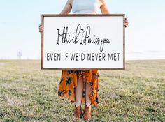 a woman holding a sign that says, i think things you even if we'd never met