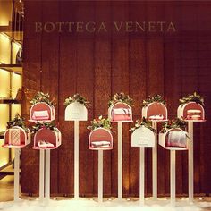 several mail boxes are lined up in front of a wooden wall with lights on it