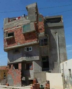 an apartment building is being built on the side of a street