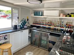 a kitchen filled with appliances and lots of bottles