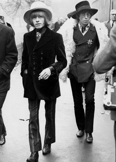 black and white photograph of people walking down the street