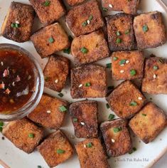 tofu cubes on a plate with dipping sauce