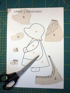 scissors and paper cut out to make a doll