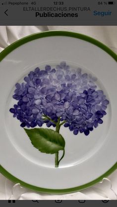 a plate with purple flowers painted on it