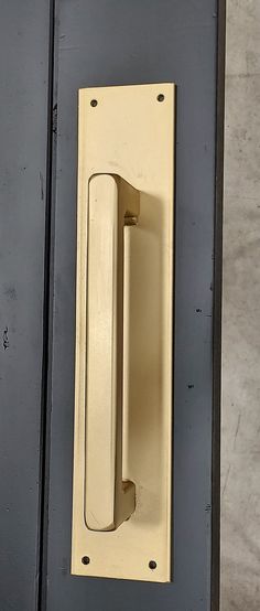 an old door handle on the side of a black door with a white knob in it