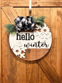 a wooden door with a sign that says hello winter