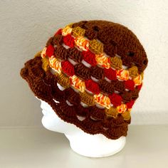 a crocheted hat on top of a white mannequin head