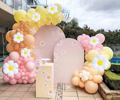 balloons and flowers are on display in front of a building