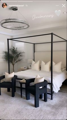 a bedroom with four poster bed and white pillows