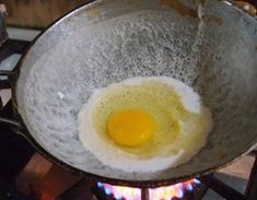 an egg frying in a skillet on the stove