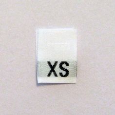 a close up of a label with the letter xs on it's side