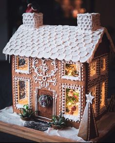 a gingerbread house decorated with icing and lights