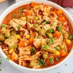 a white bowl filled with chicken and vegetable soup