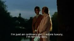 two people standing next to each other in front of a lake with the caption i'm just an ordinary girl i adore luxury, i am terribly lazy